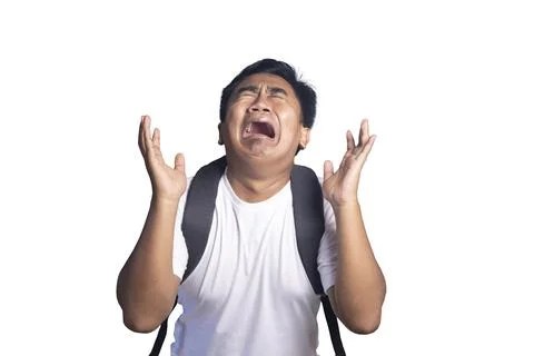 Young man wearing a backpack crying out in frustration and despair with han.. Stock Photos