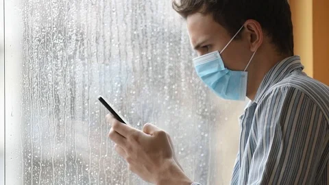 Young  man wearing a face mask, sick and quaranteened Stock Footage 126100367