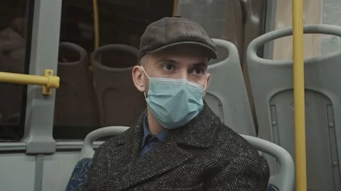 Young man wearing face mask travelling in the bus Stock Footage 168537553