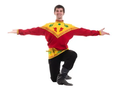 Young man wearing a folk russian costume dancing against isolated white with Stock Photos