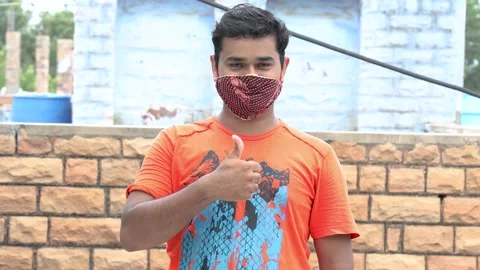 Young Man Wearing Mask Doing Thumbs Up During Covid-19 Pandemic Stock Footage 136614853