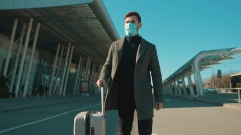 Young man wearing Protective Face Mask walk near airport pandemic disease virus Stock Footage 126575544