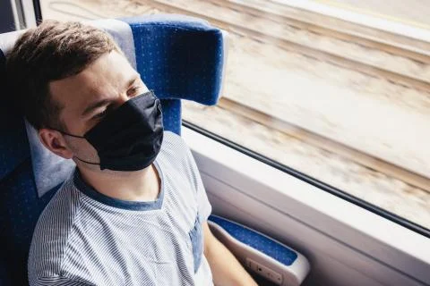 Young man wearing protective face mask sitting in the traing Stock Photos