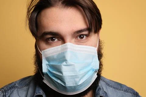 Young man wearing protective mask again Covid-19. Corona virus. Isolated. Fotos de archivo