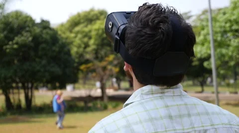 Young man wearing virtual reality goggles outside Stock Footage 67612759