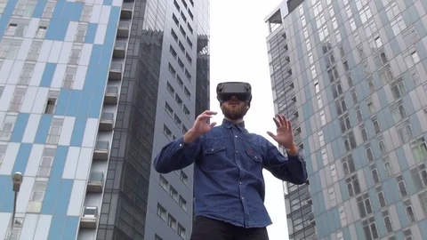 Young Man wearing virtual reality goggles outdoor Stock Footage 74059204