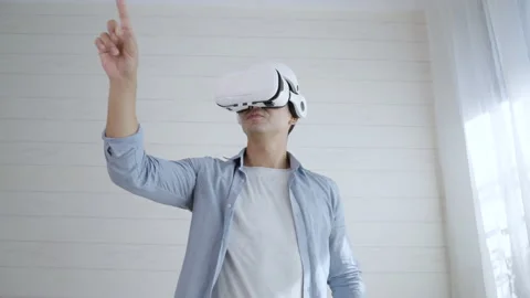 Young man wearing Virtual reality glass touching simulation screen on the air Stock Footage 166033575
