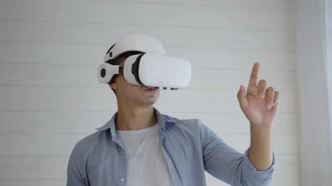Young man wearing Virtual reality glass touching simulation screen on the air Stock Footage 166036904