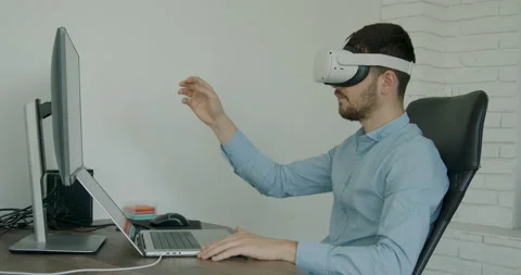 Young man wearing virtual reality glasses in the office Stock Footage 201271498