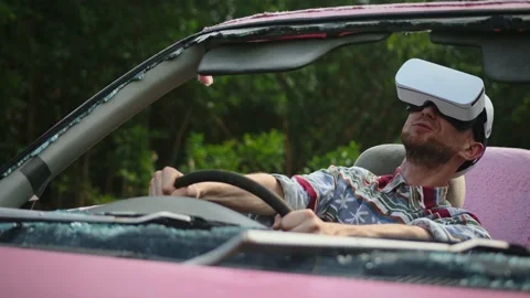 Young man wearing virtual reality headset drives fast in car at high speed Stock Footage 236848115