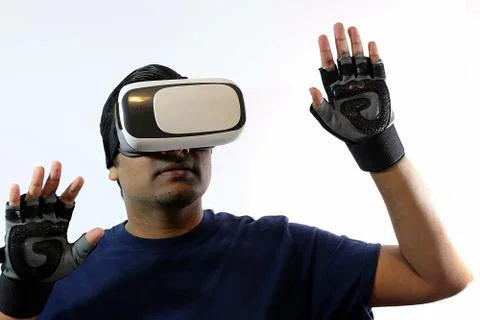 Young man wearing virtual reality headset goggles Stock Photos