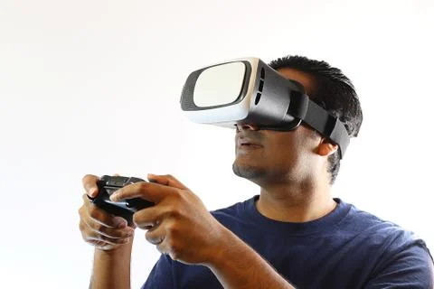 Young man wearing virtual reality headset goggles Stock Photos