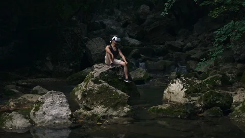 Young man wearing VR glasses and discovering simulating new forest nature world Stock Footage 104270587