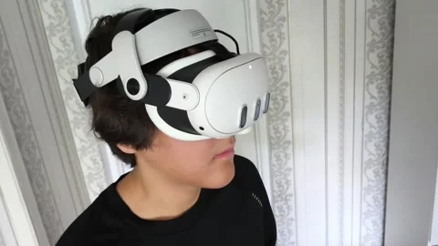 Young man wearing VR glasses interacting with 3d objects in augmented virtual Stock Footage 313187529