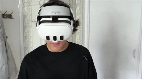 Young man wearing VR glasses interacting with 3d objects in augmented virtual Stockbeeldmateriaal 313187727