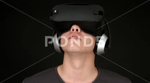 Young Man Wearing VR Headset And Experiencing Virtual Reality Stock Photos