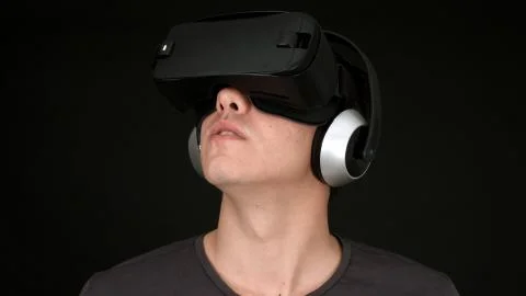 Young Man Wearing VR Headset And Experiencing Virtual Reality Stock Photos