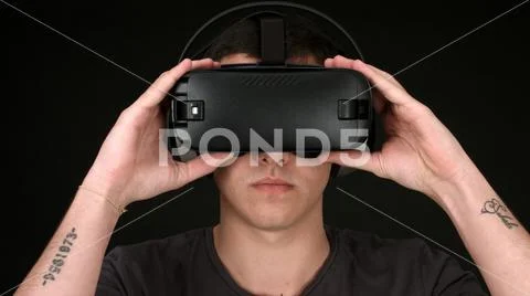 Young Man Wearing VR Headset And Experiencing Virtual Reality Stock Photos