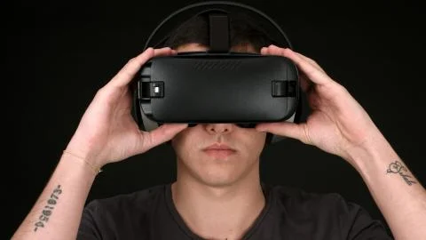 Young Man Wearing VR Headset And Experiencing Virtual Reality Stock Photos