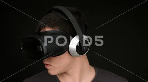 Young Man Wearing VR Headset And Experiencing Virtual Reality Stock Photos