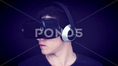 Young Man Wearing VR Headset And Experiencing Virtual Reality - Blue Concept Stock Photos