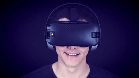 Young Man Wearing VR Headset And Experiencing Virtual Reality - Blue Concept Stock Photos