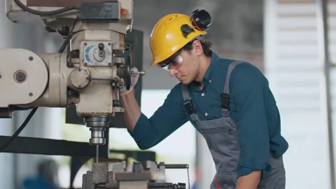 Young man wears hard hat and safety glasses Видео 346153564