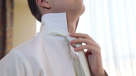 A young man wears a tie and fastens with buttons. Stock Footage 47190838