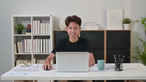 Young man website developer opening and typing on laptop computer, enjoying Stock Footage 236227128