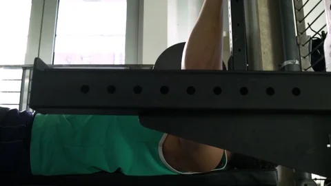 Young man weightlifting in a gym Stock-Footage 77082011