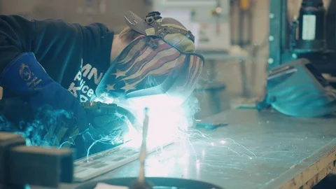 Young man welds two pieces of metal together Stock-Footage 103337490
