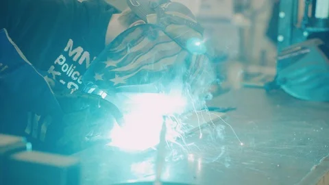 Young man welds two pieces of metal together Stock-Footage 103337583