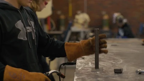 Young man welds two pieces of metal together Stock-Footage 103338136