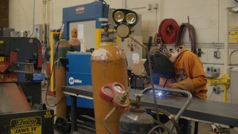 Young man welds two pieces of metal together Stock-Footage 103338451