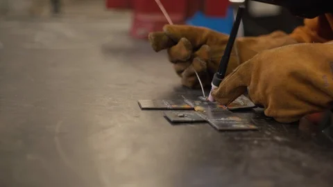 Young man welds two pieces of metal together Stock-Footage 103338523