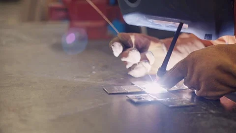 Young man welds two pieces of metal together Stock-Footage 103338622