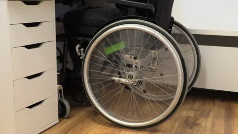 Young man in a wheelchair at a workplace at a computer Video stock 125334502
