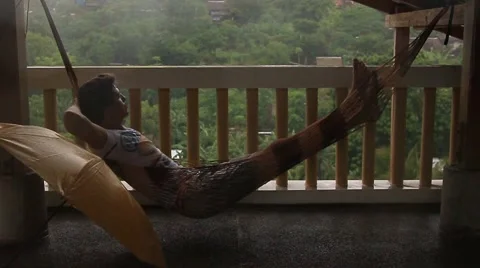 The Young Man Which is Conveniently Located in a Hammock Stock Footage 58914208