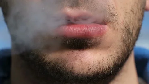 Young man while blowing out cigarette smoke,tobacco addiction,unhealty lifestyle Stock Footage 146100120