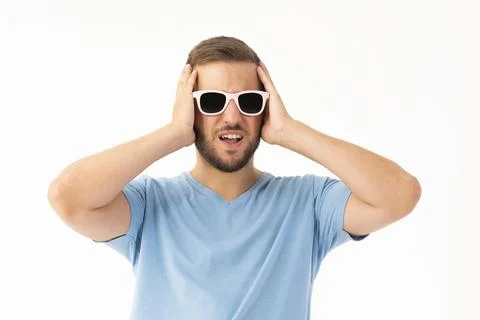 Young man on white background making a frightened expression Stock Photos