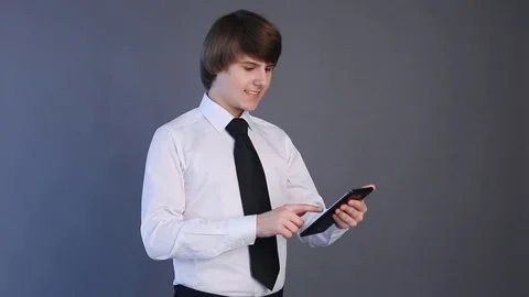 Young man in white shirt using tablet computer touchscreen. Handsome student Video stock 74264934