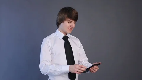 Young man in white shirt using tablet computer touchscreen. Handsome student Video stock 74265218