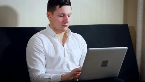 Young Man in White Shirt Working on Laptop. Serious Handsome Guy Typing, Using Stock Footage 72017534
