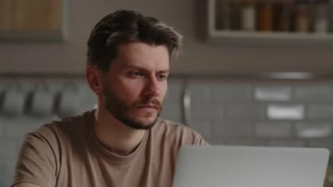 Young man who is focused on working at a computer. Freelancer found a solution Stock Footage 238931724