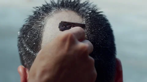 The young man whose head was shaved during the ordination ceremony Stock Footage 134364191