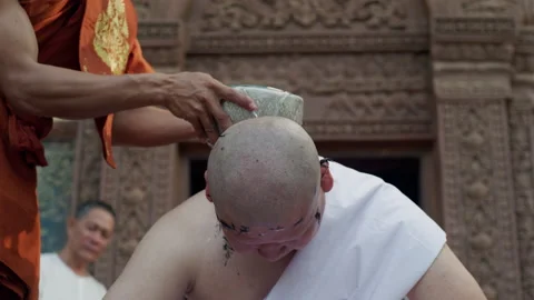The young man whose head was shaved during the ordination ceremony Stock Footage 134389722