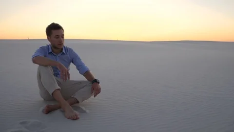 Young man with wide open arms on desert enjoying sunny day Stock Footage 83603022