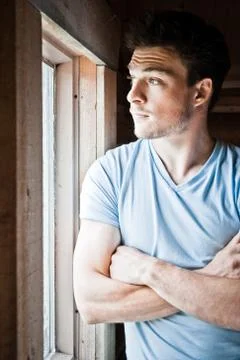 Young man at the window Stock-Fotos