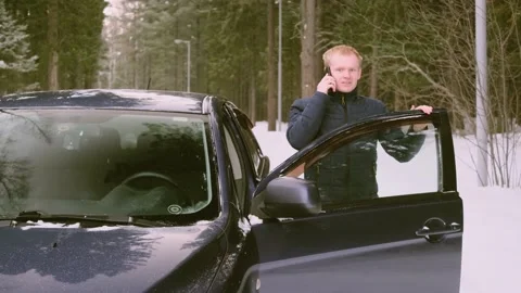A young man in the winter on the car Stock Footage 150992748