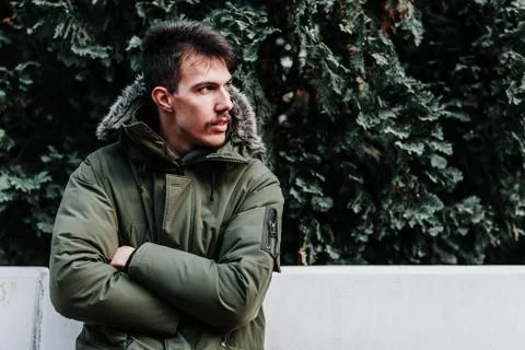 Young man in winter jacket posing outdoors 스톡 사진